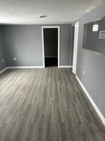 a view of an empty room and wooden floor