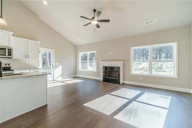 a view of a kitchen with a stove cabinets wooden floor and a kitchen