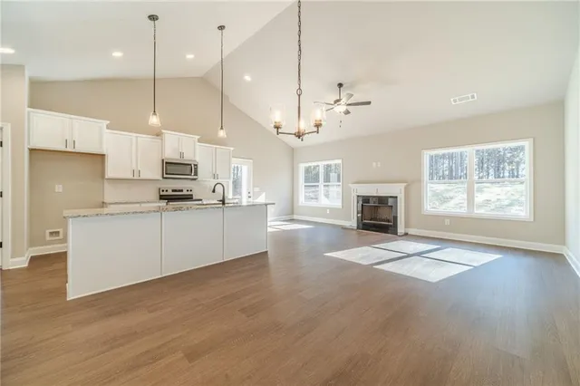 a view of kitchen with cabinets and wooden floor