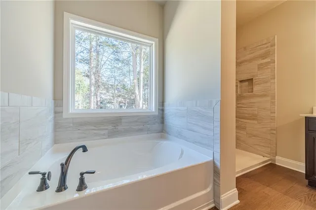 a bathroom with a tub and shower
