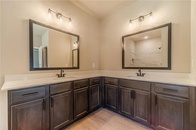 a bathroom with a double vanity sink and mirror