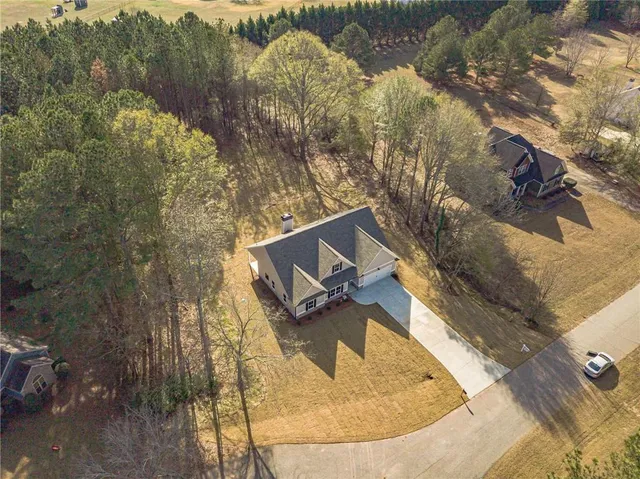 an aerial view of a house with a yard and lake view