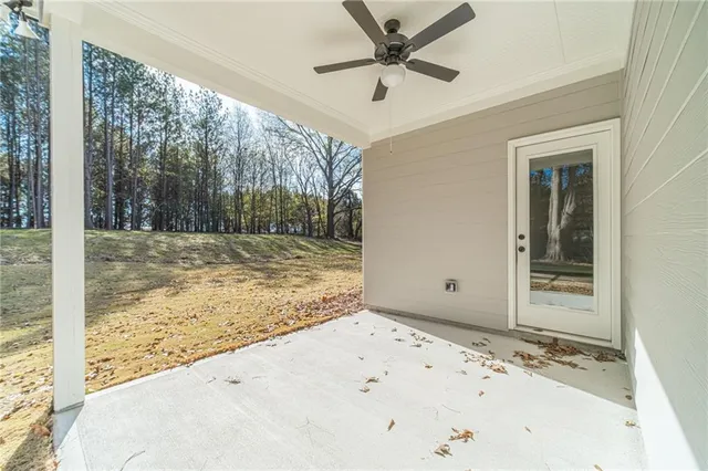 a view of a livingroom with wooden floor and a ceiling fan