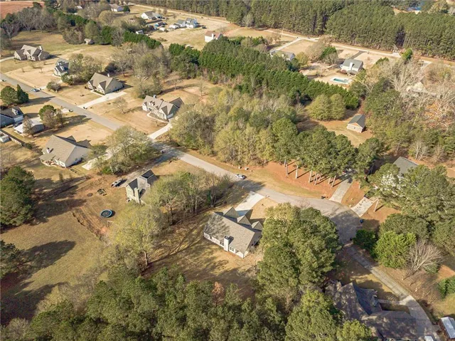 a aerial view of a residential houses with yard