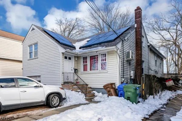 a view of a car parked front of a house