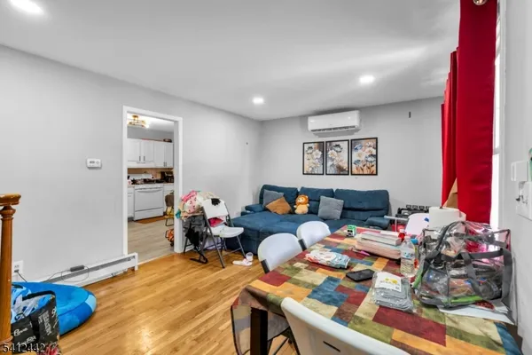 a playing room with furniture and a wooden floor