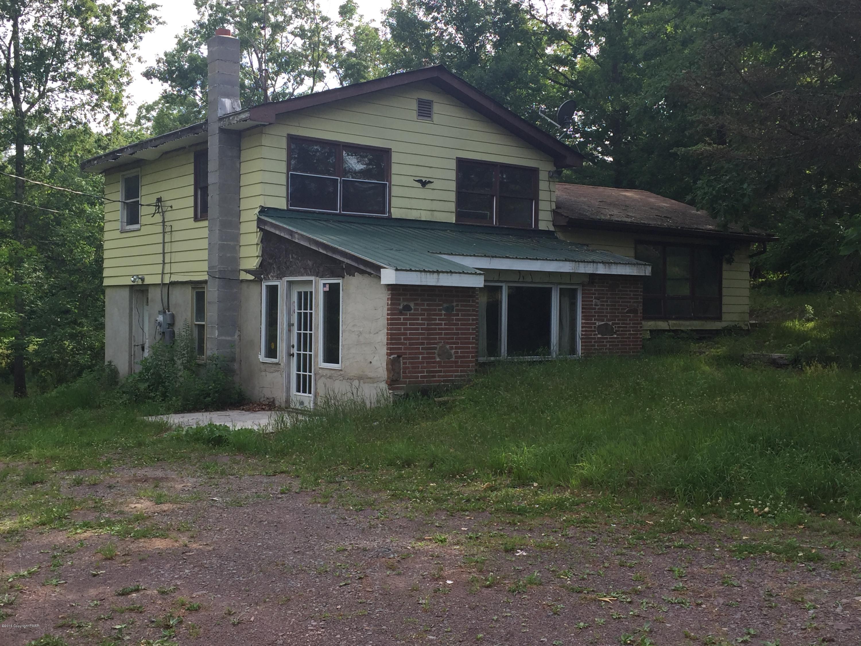 220 Lower Grandview Road Cresco, PA 18326 - Photo 1 of 10 a front view of a house with garden