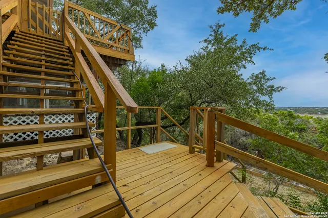 a view of balcony with wooden floor and fence