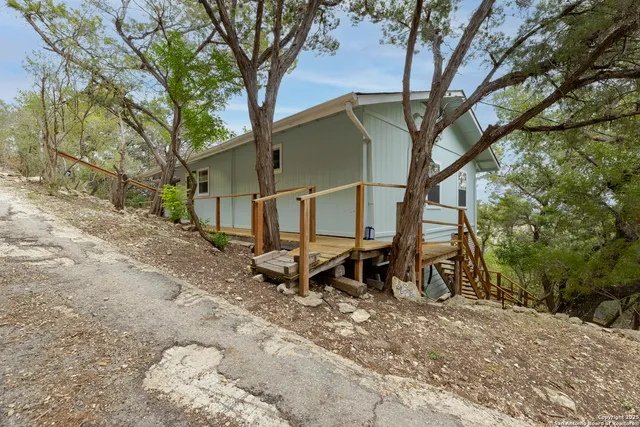 a backyard of a house with table and chairs