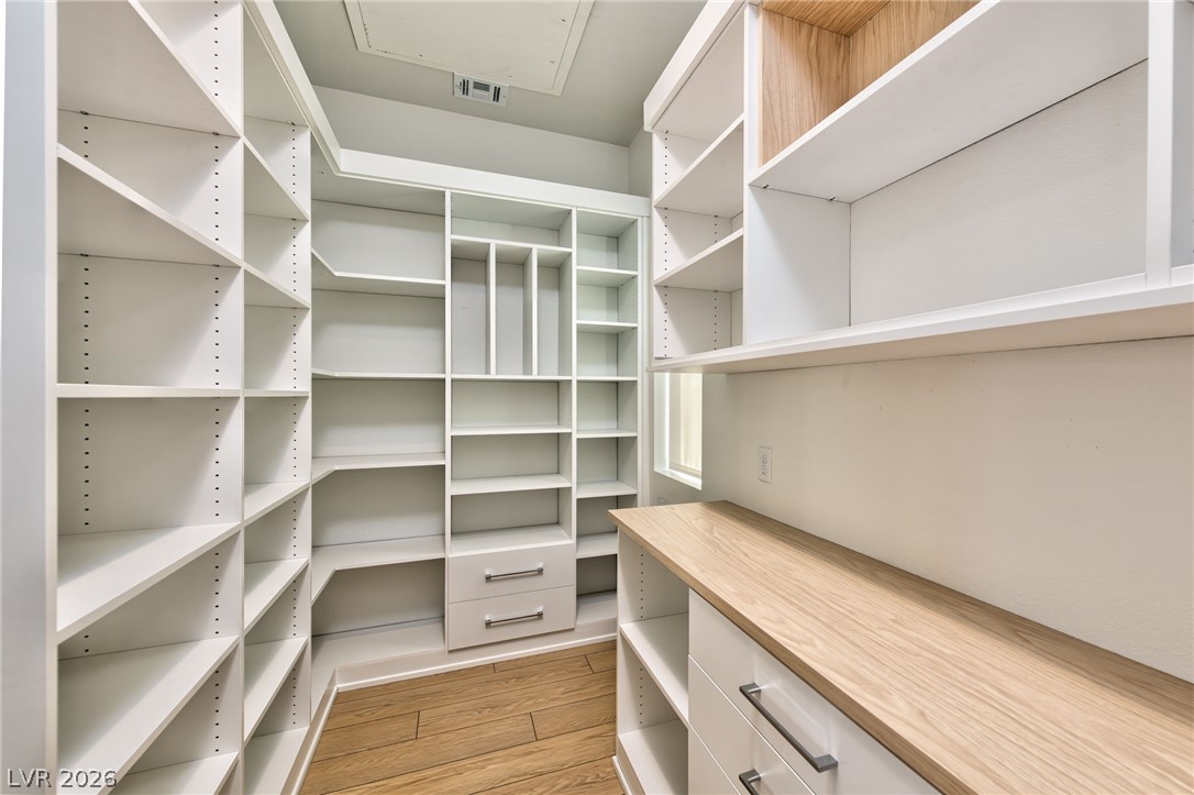 3327 Esker Rdg Avenue Henderson, NV 89044 - Photo 8 of 24 Customizable shelving and storage drawers define this naturally illuminated walk-in closet.