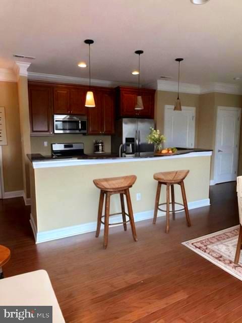 756 Street Road, Unit 17 Southampton, PA 18966 - Photo 11 of 31 a kitchen with a table chairs refrigerator and microwave
