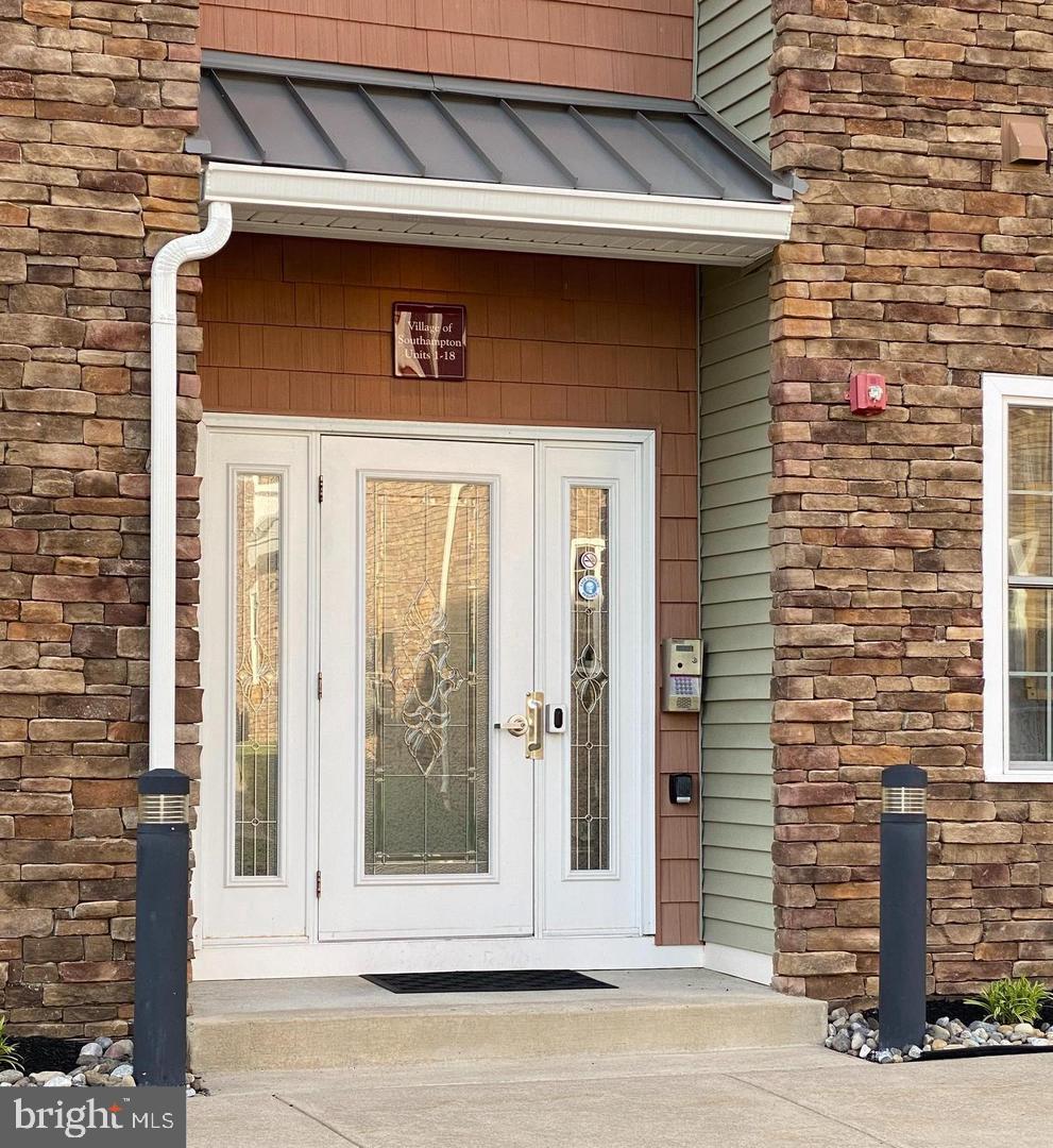 756 Street Road, Unit 17 Southampton, PA 18966 - Photo 2 of 31 a front view of a house with a garden