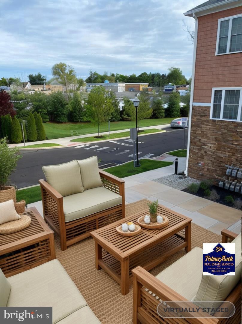 756 Street Road, Unit 17 Southampton, PA 18966 - Photo 22 of 31 a view of a patio with couches table and chairs with wooden floor