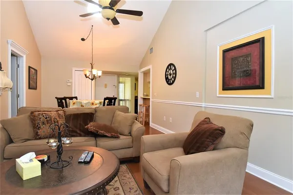 a living room with furniture and a chandelier