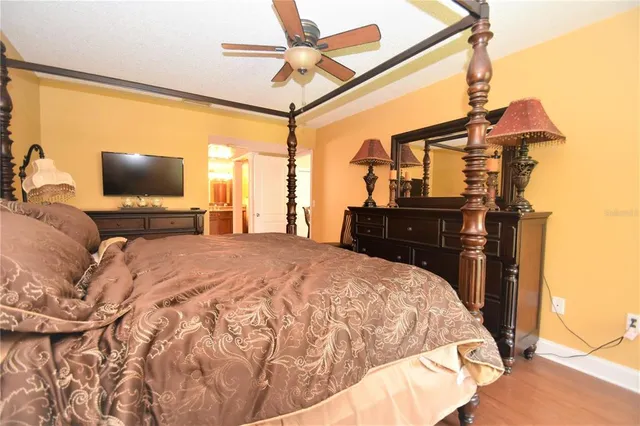 a bedroom with a bed and dresser with mirror