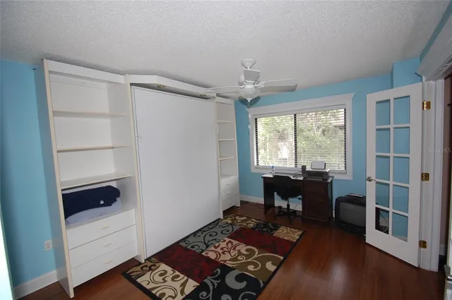 a view of a workspace with furniture and a window