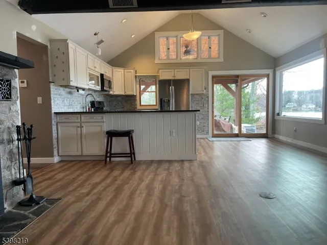 a kitchen with cabinets and wooden floor