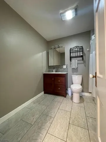 a spacious bathroom with a vanity and a toilet