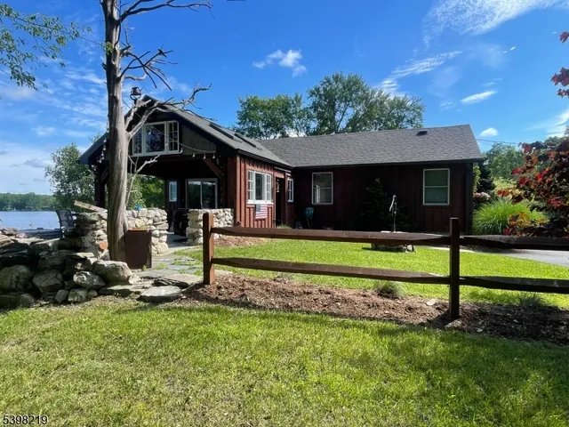a front view of a house with a yard table and chairs