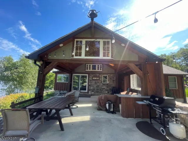 a view of a patio with table and chairs potted plants with wooden floor