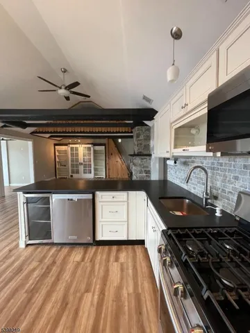a kitchen with granite countertop a stove and a sink