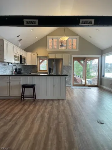 a kitchen with stainless steel appliances granite countertop a stove and cabinets