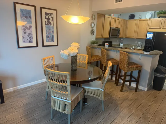 a view of a dining room with furniture and wooden floor