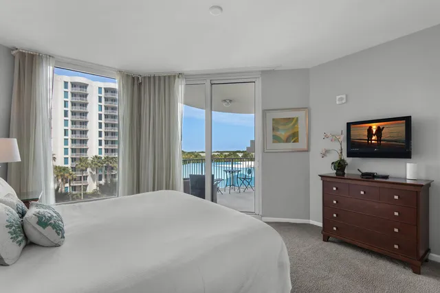 a bedroom with a bed and large window