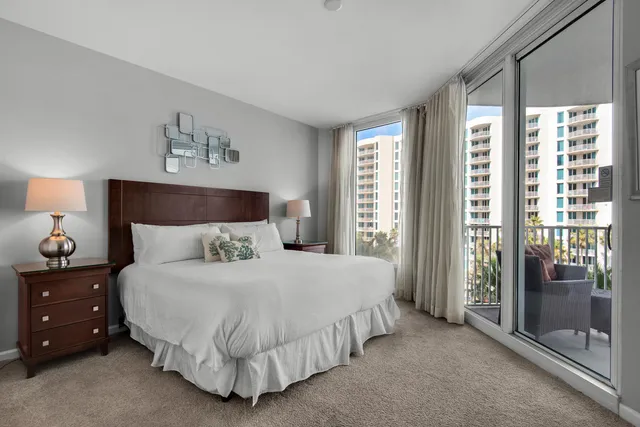 a bed sitting in a bedroom next to a window with lamp