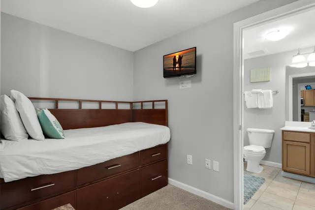 a bedroom with a bed and cabinet