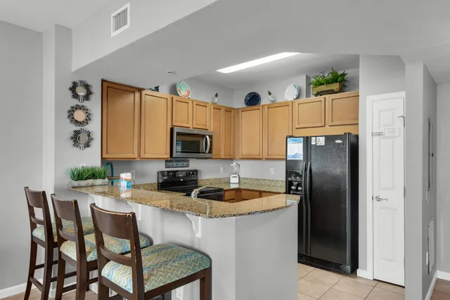 a kitchen with sink refrigerator and cabinets