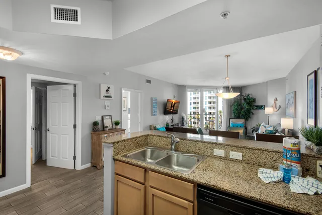 a kitchen with stainless steel appliances granite countertop a refrigerator sink and stove