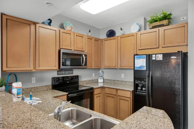 a kitchen with a refrigerator sink and microwave