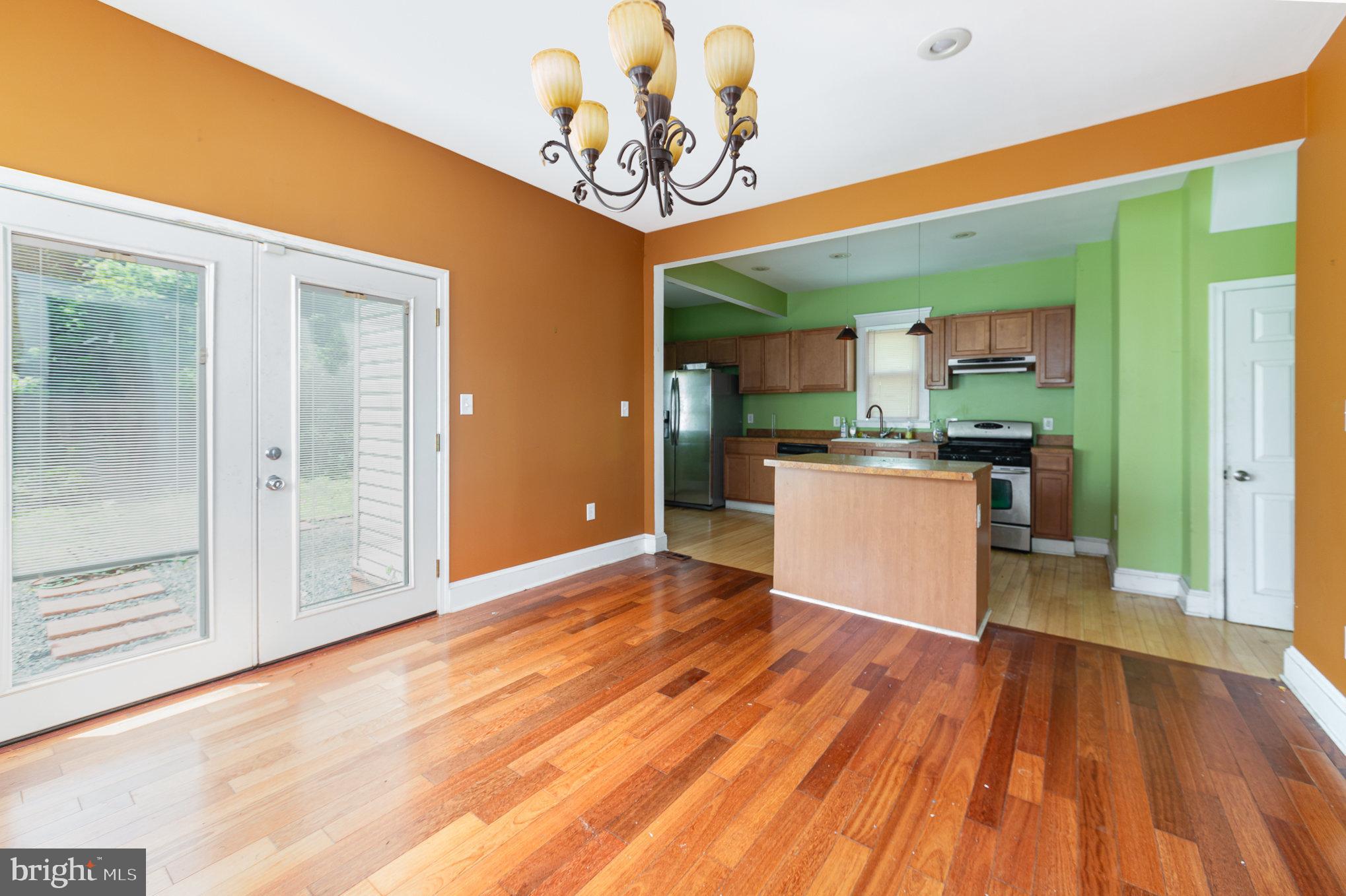 2404 Allendale Road Baltimore, MD 21216 - Photo 13 of 30 a view of a kitchen with a fridge and wooden floor
