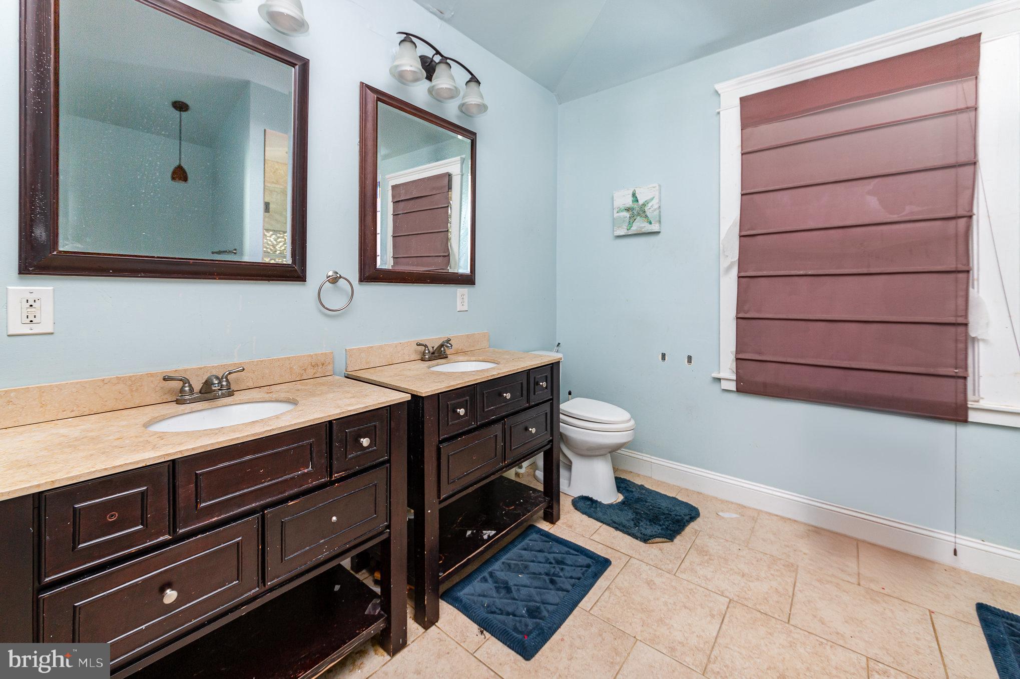 2404 Allendale Road Baltimore, MD 21216 - Photo 18 of 30 a bathroom with a sink and a mirror