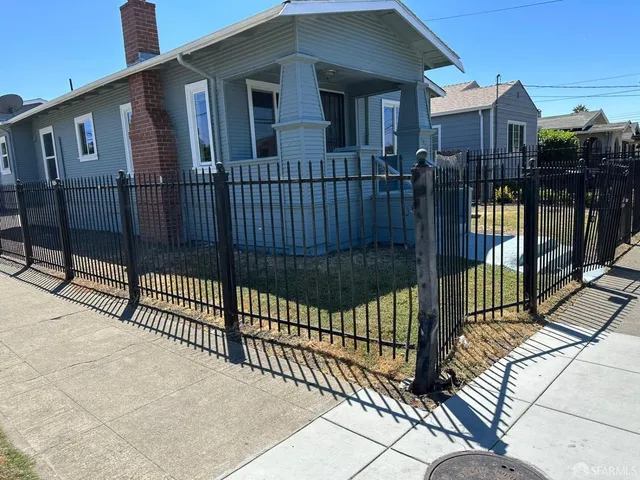 a view of a house with iron fence
