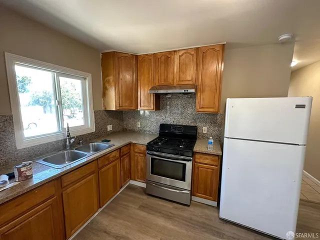 a kitchen with a white cabinets and white appliances