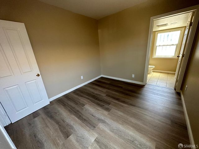 a view of room with window and wooden floor
