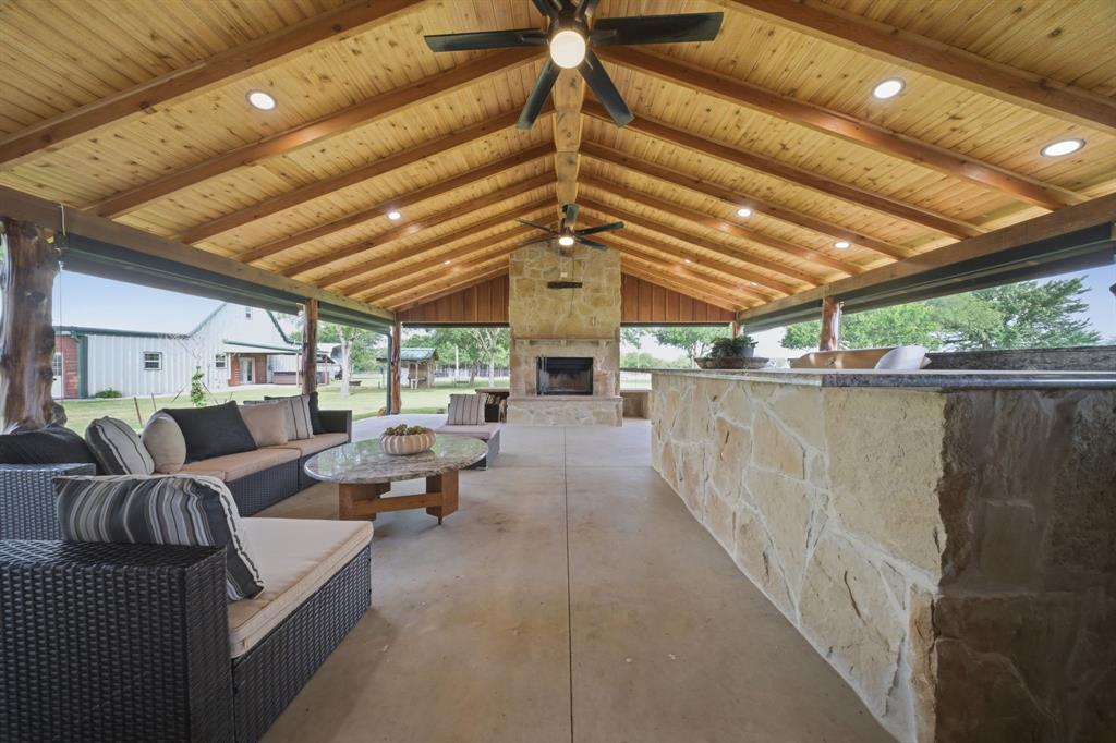 465 Emberson Ranch Road Pilot Point, TX 76258 - Photo 27 of 40 a living room with furniture a chandelier
