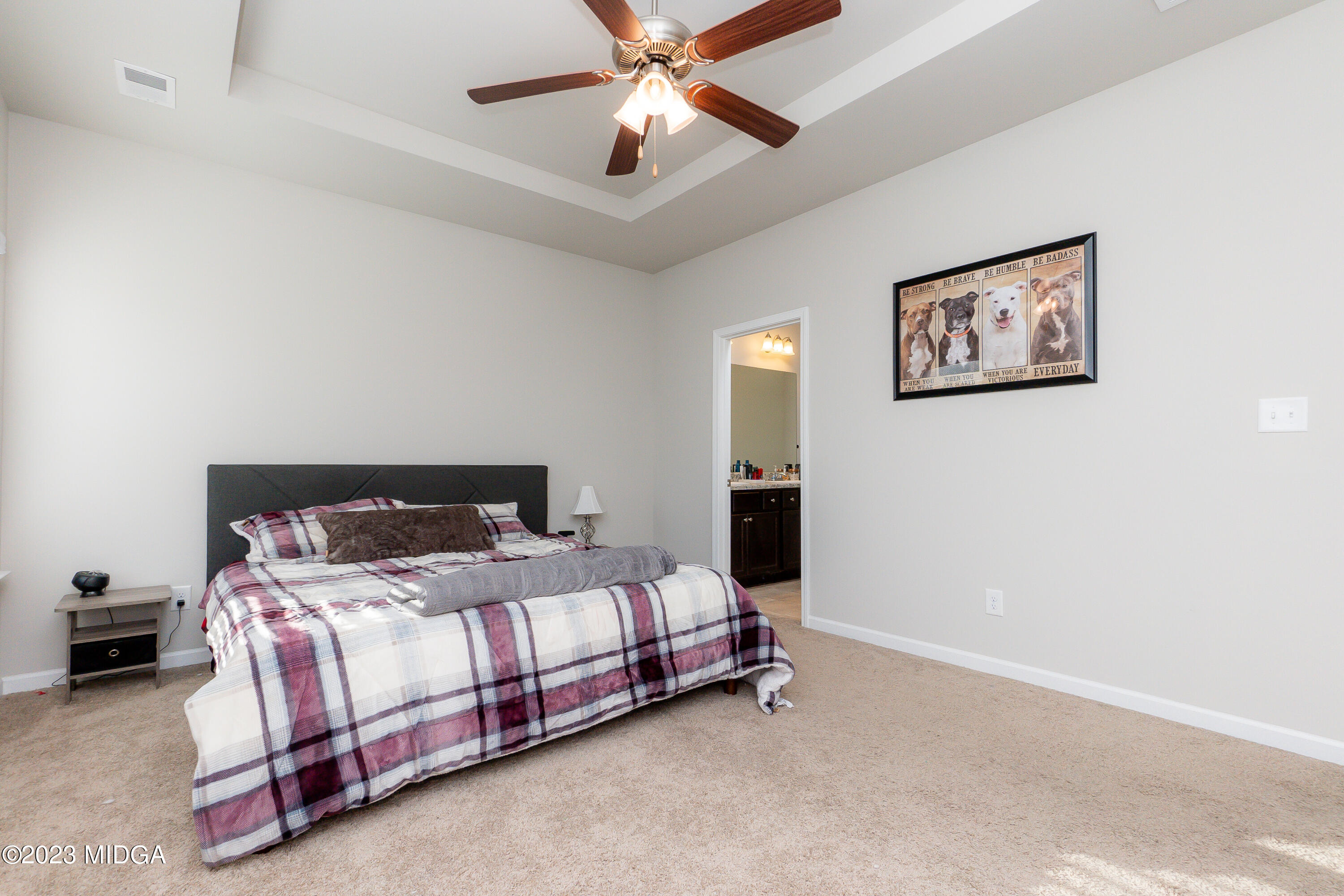 103 Longbridge Way Perry, GA 31069 - Photo 29 of 53 a bedroom with a bed and a chandelier