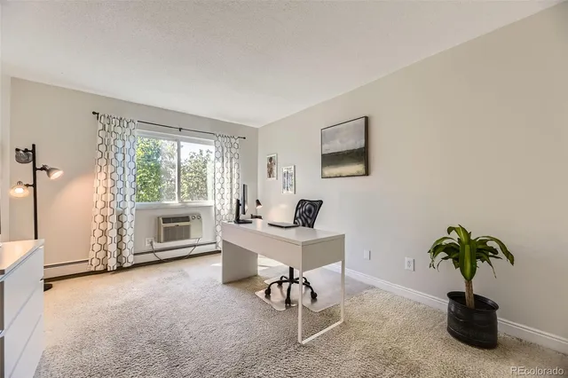 a view of a livingroom with furniture and a potted plant