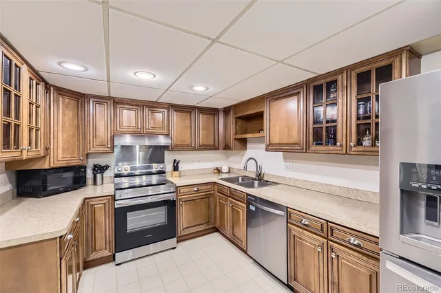 a kitchen with a sink stainless steel appliances and cabinets