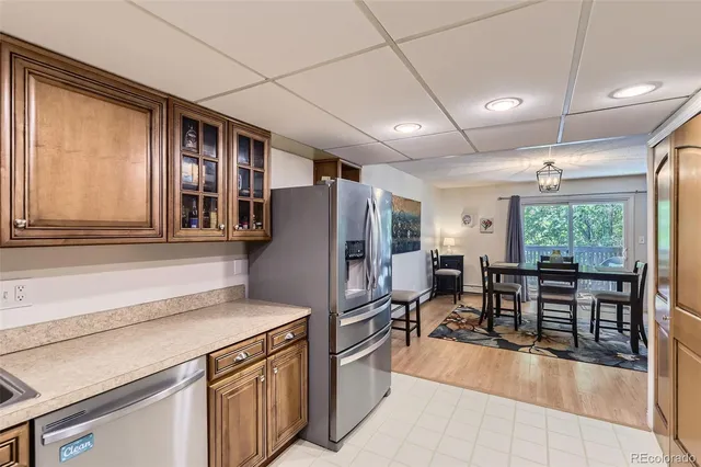 a kitchen with stainless steel appliances granite countertop a refrigerator and a stove top oven