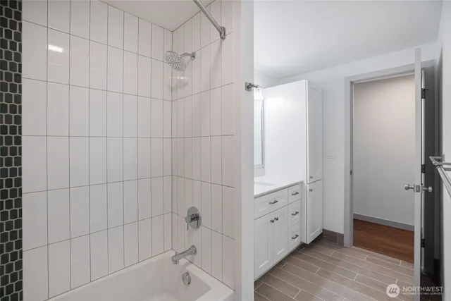 a bathroom with a bathtub and a shower