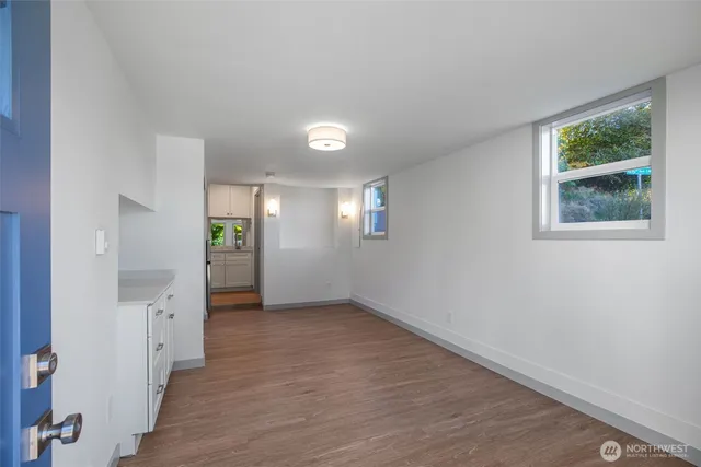 an empty room with windows and entrance