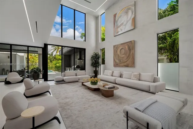 a living room with furniture fireplace and large window