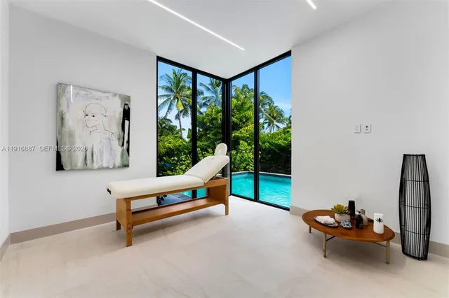 a living room with furniture and a floor to ceiling window