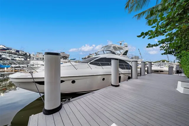 a view of a balcony with cars parked on the road