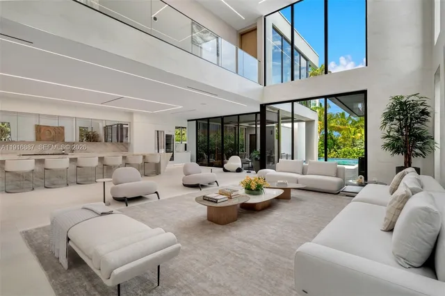 a living room with furniture fireplace and a large window