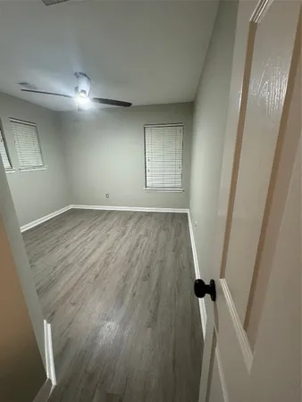 wooden floor in an empty room with a mirror